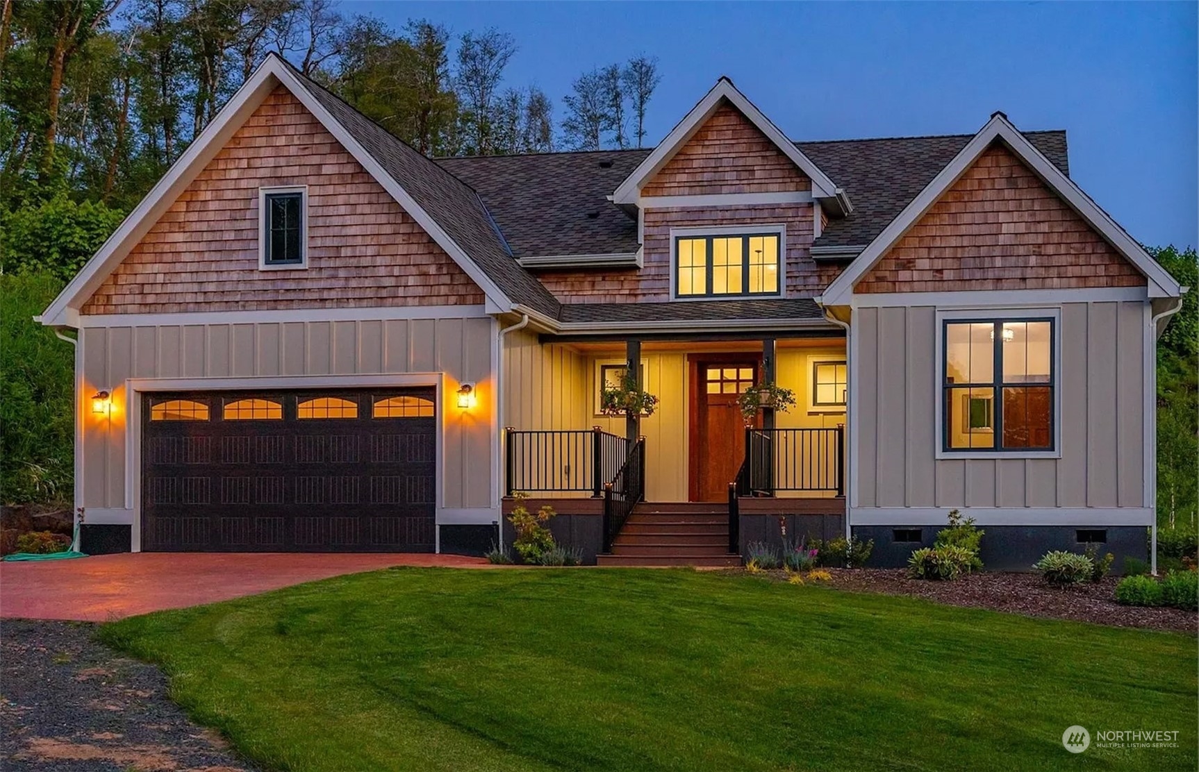 a front view of a house with a yard and garage