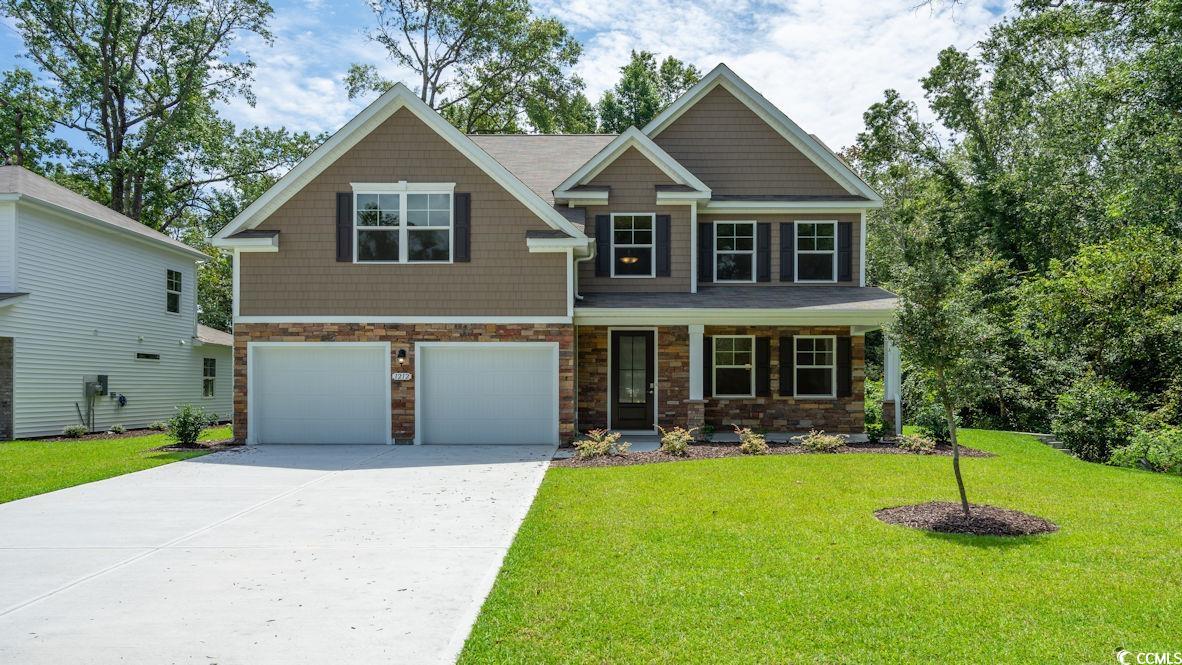 Craftsman-style home with a garage and a front yar