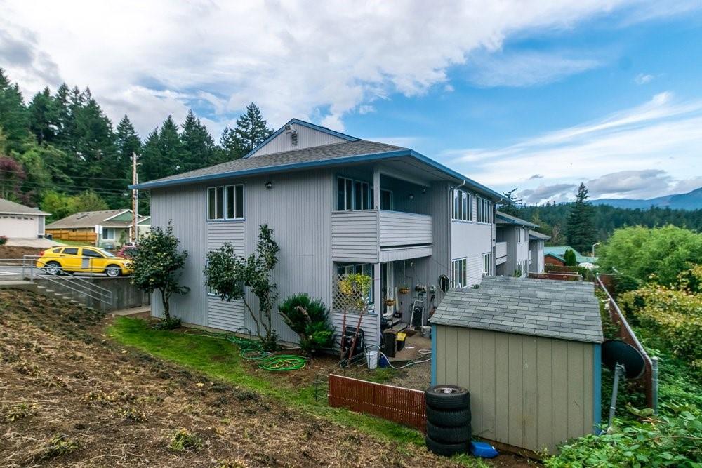 a view of house with outdoor space and sitting area