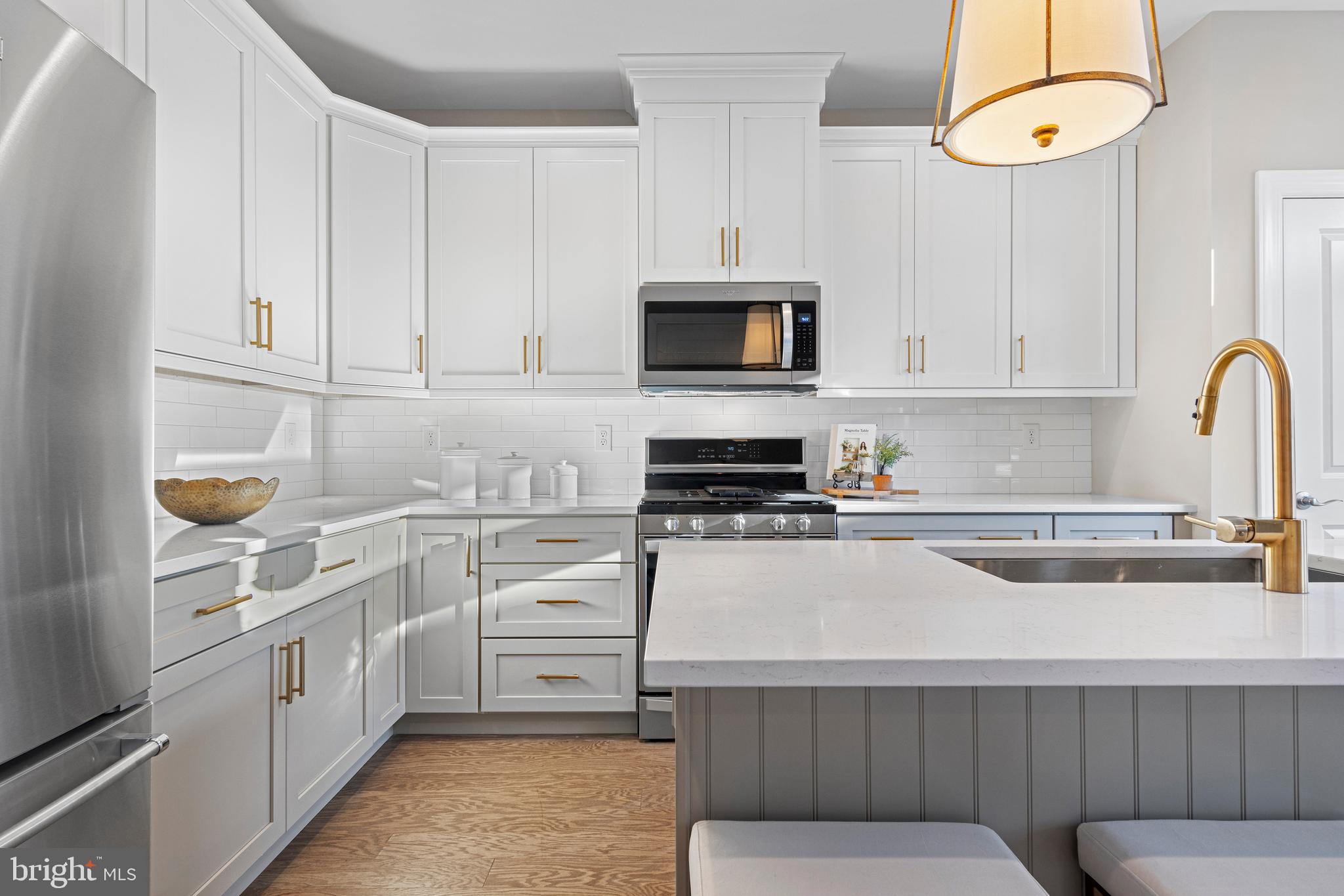 a kitchen with cabinets appliances and a sink