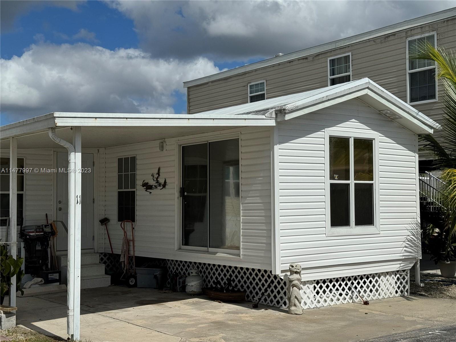 a view of a house with a wooden fence