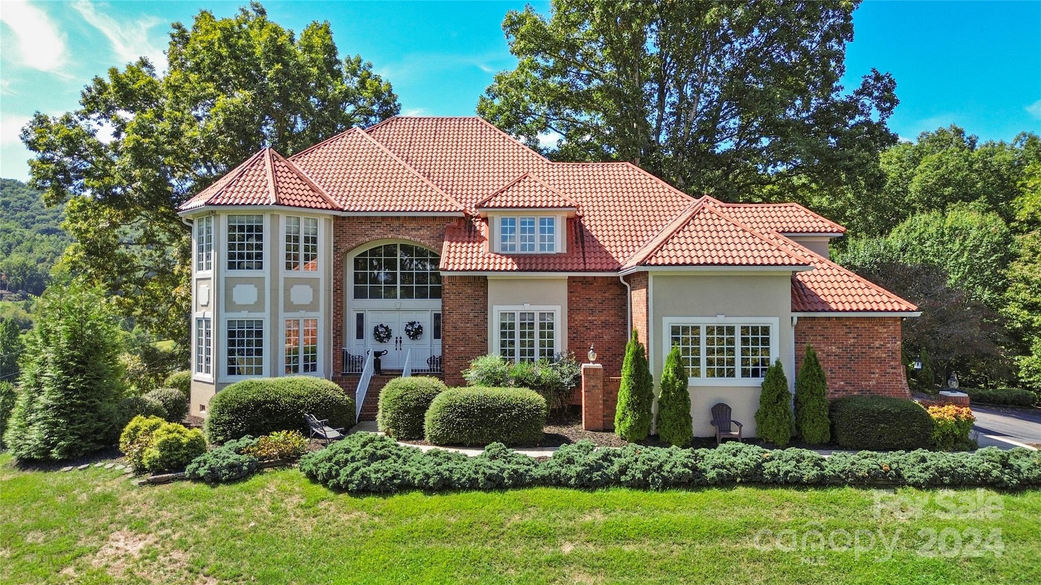 a front view of a house with a yard