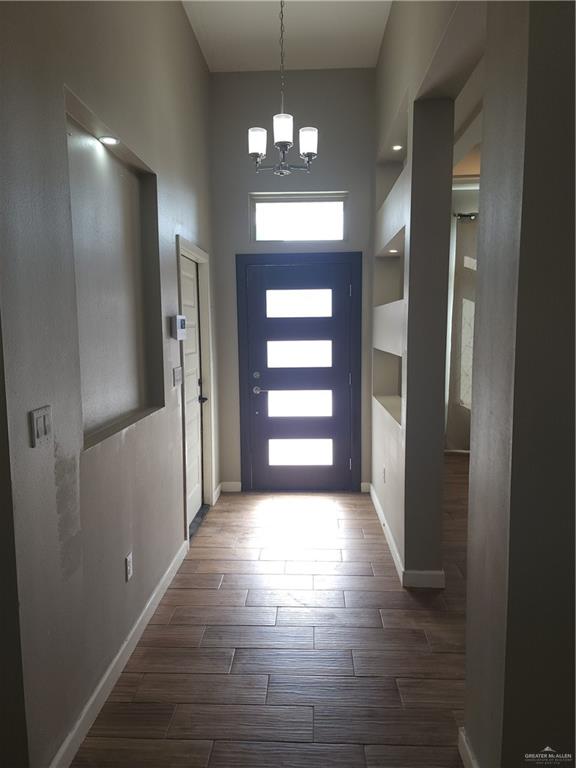 a view of a hallway view with wooden floor and staircase