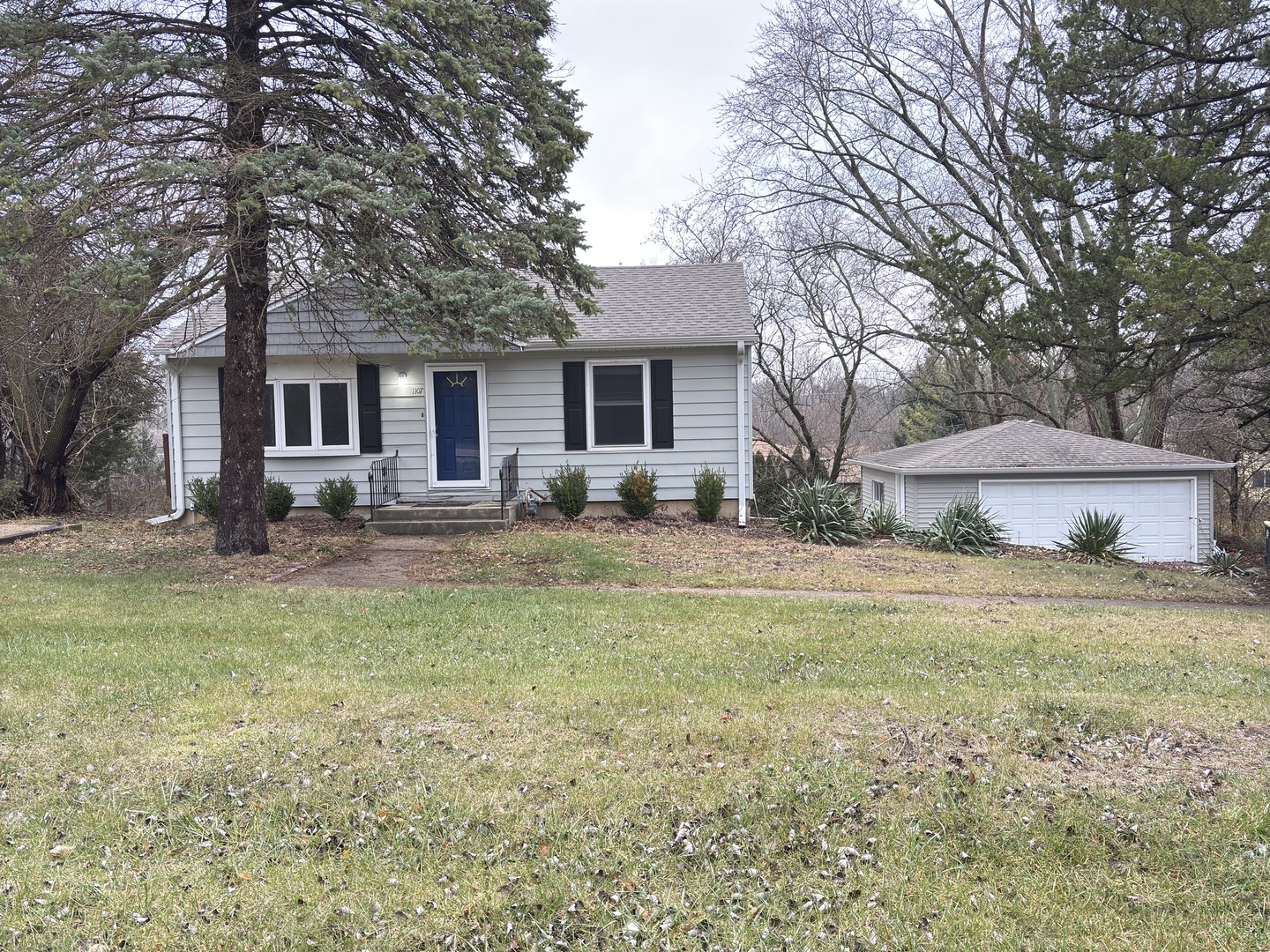 a front view of house with yard and trees