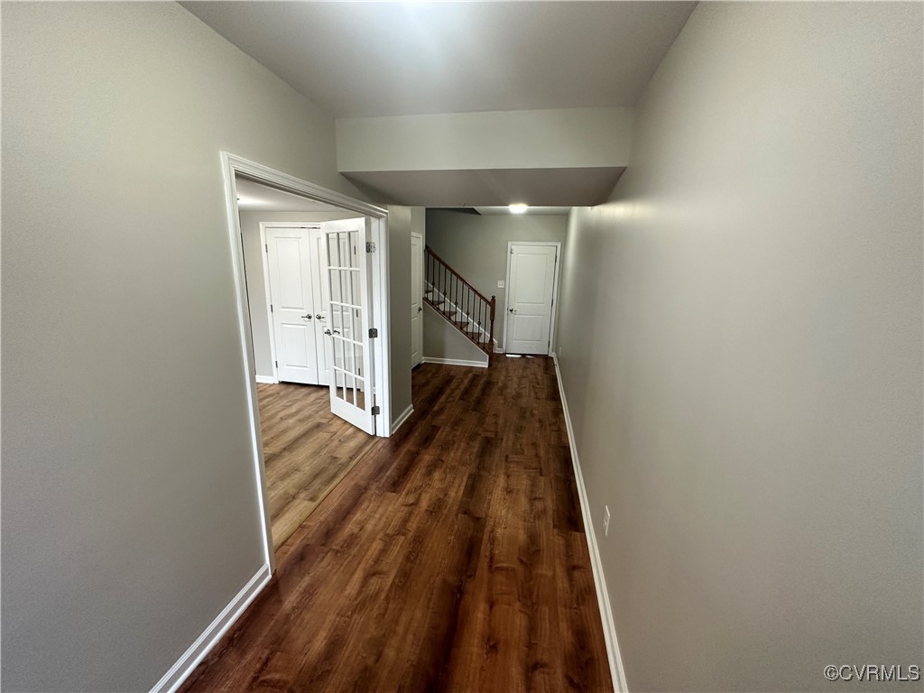 a view of a hallway with wooden floor