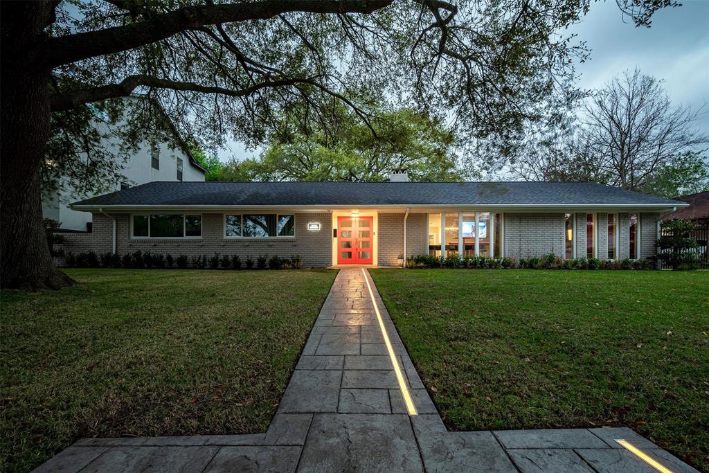 Welcome to 9718 Cliffwood, where elegant pathway lighting guides you to a modern sanctuary.