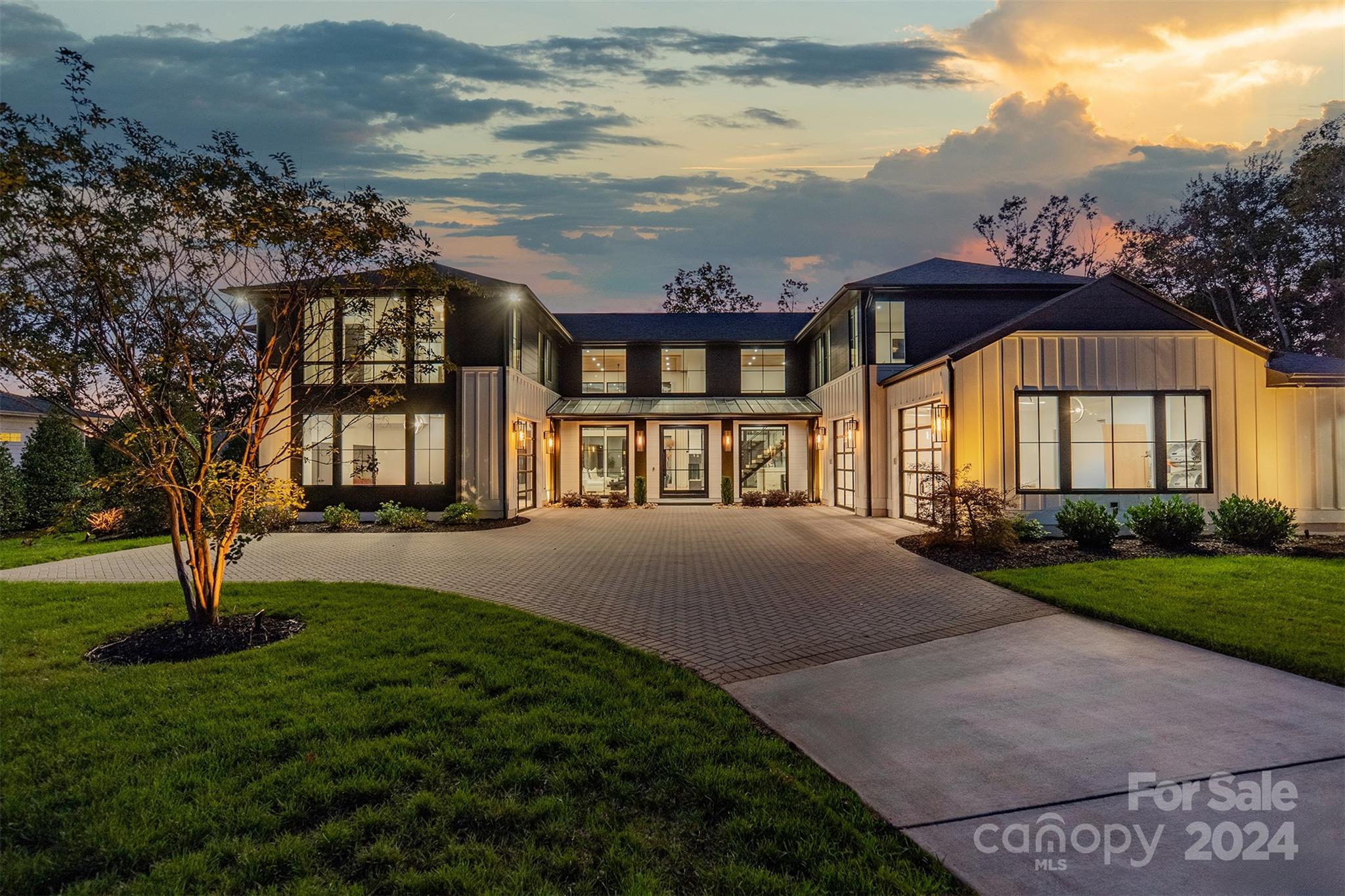 a view of a big house with a big yard and large trees