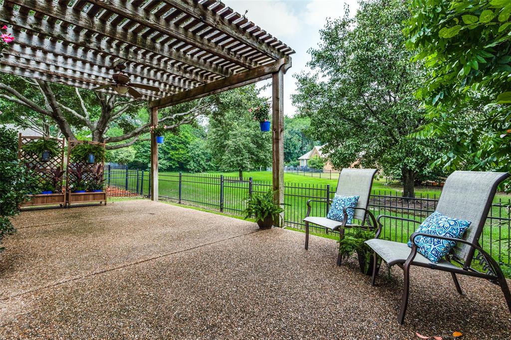 a view of a patio with table and chairs and floor to ceiling window