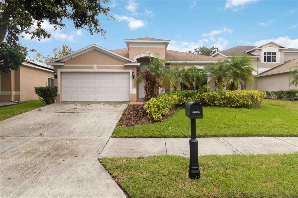 a front view of a house with a yard and garage