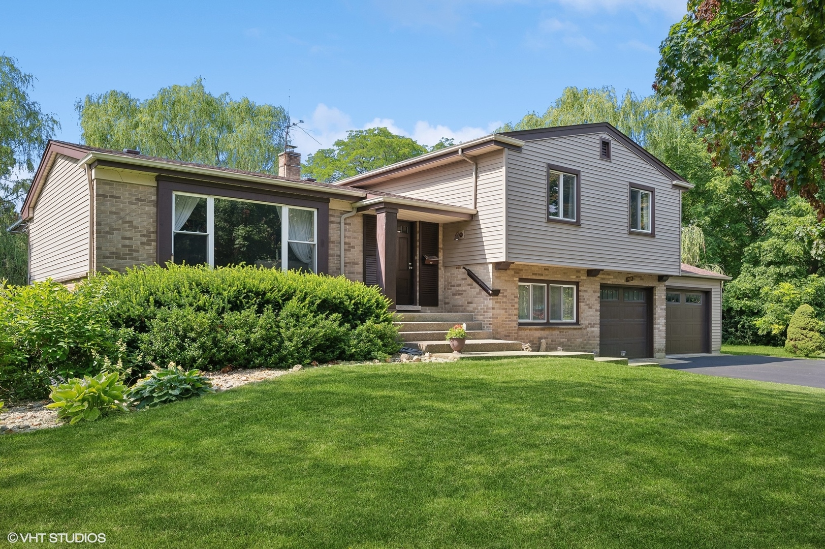 a front view of house with yard and green space