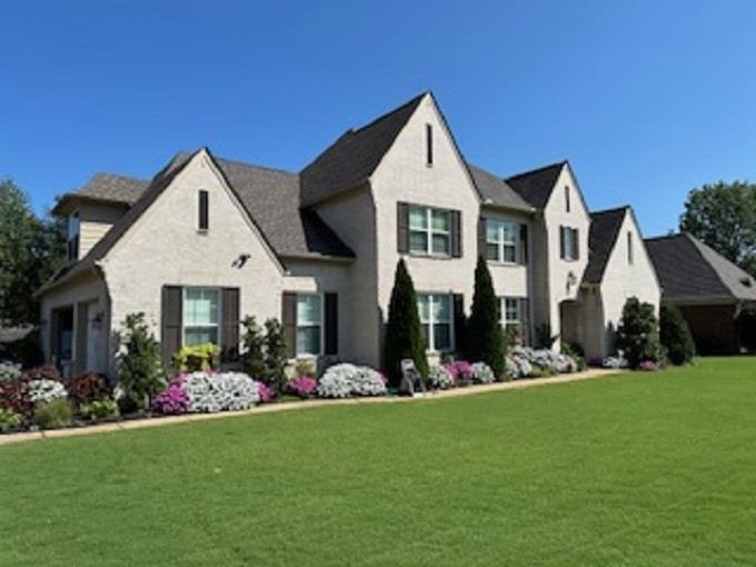 a front view of a house with a yard