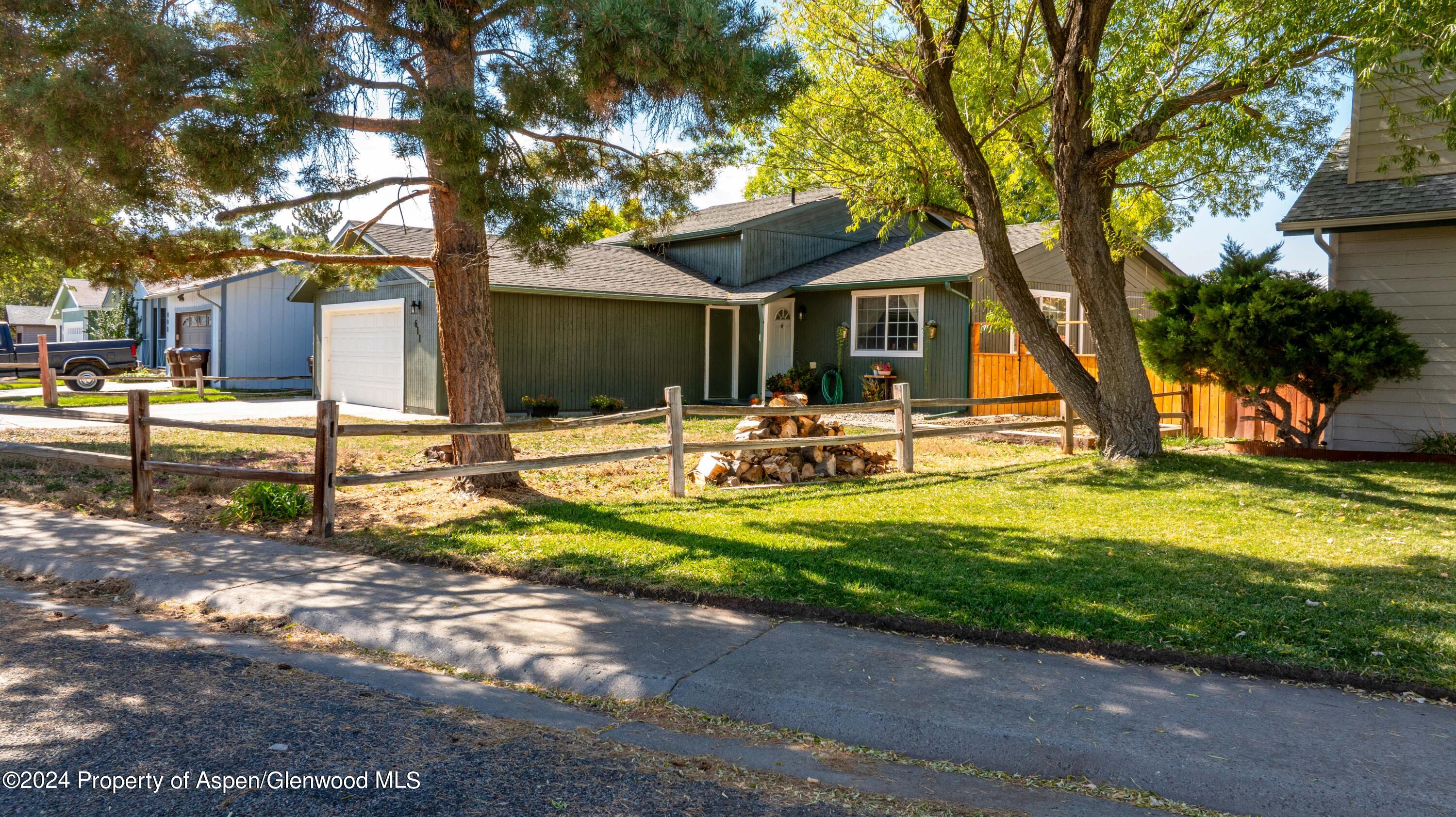 a view of a house with backyard and tree