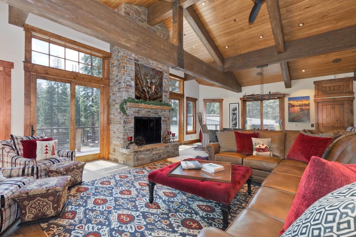 a living room with furniture large window and a fireplace