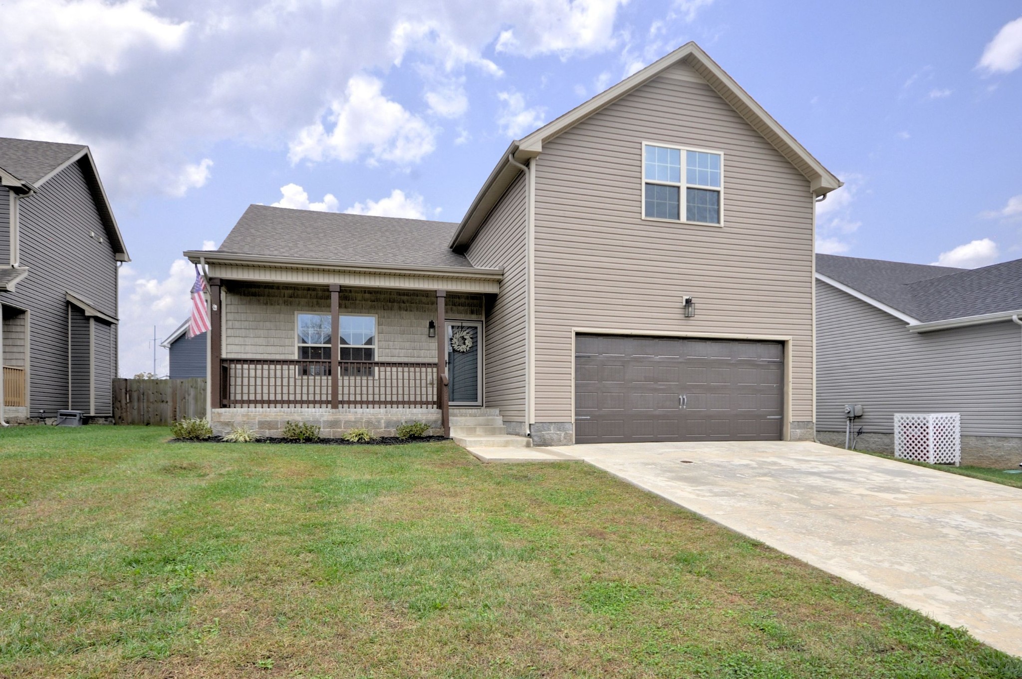 a view of a house with a yard and garage