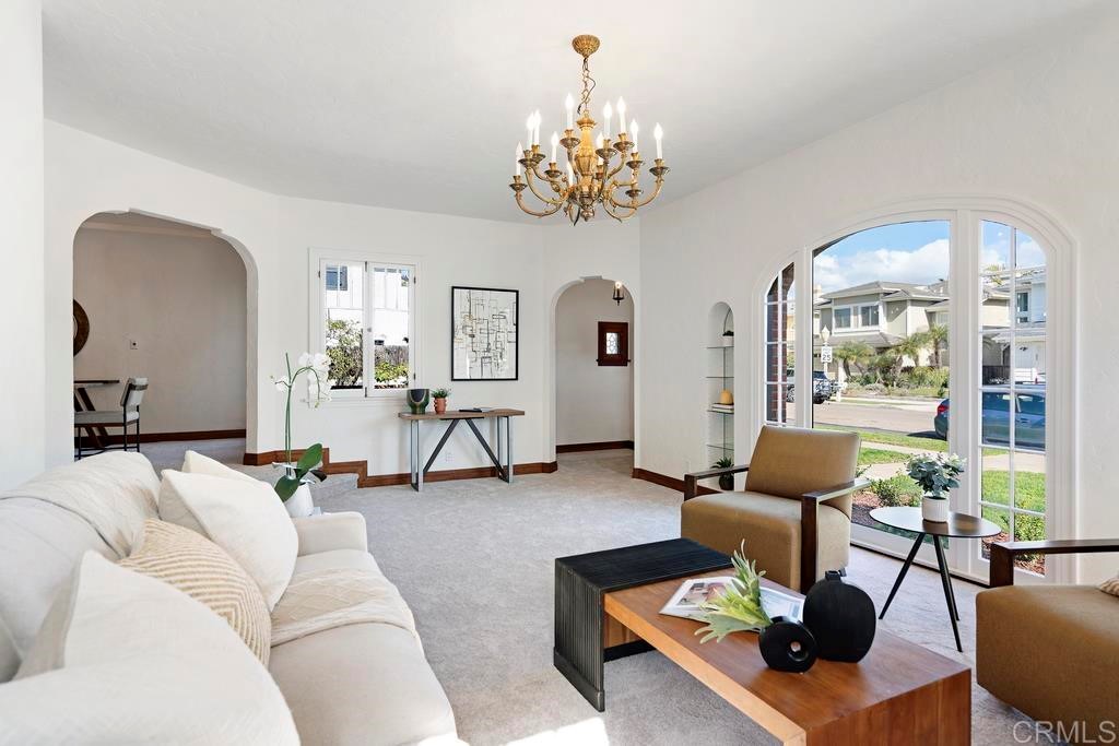 a living room with furniture and a chandelier