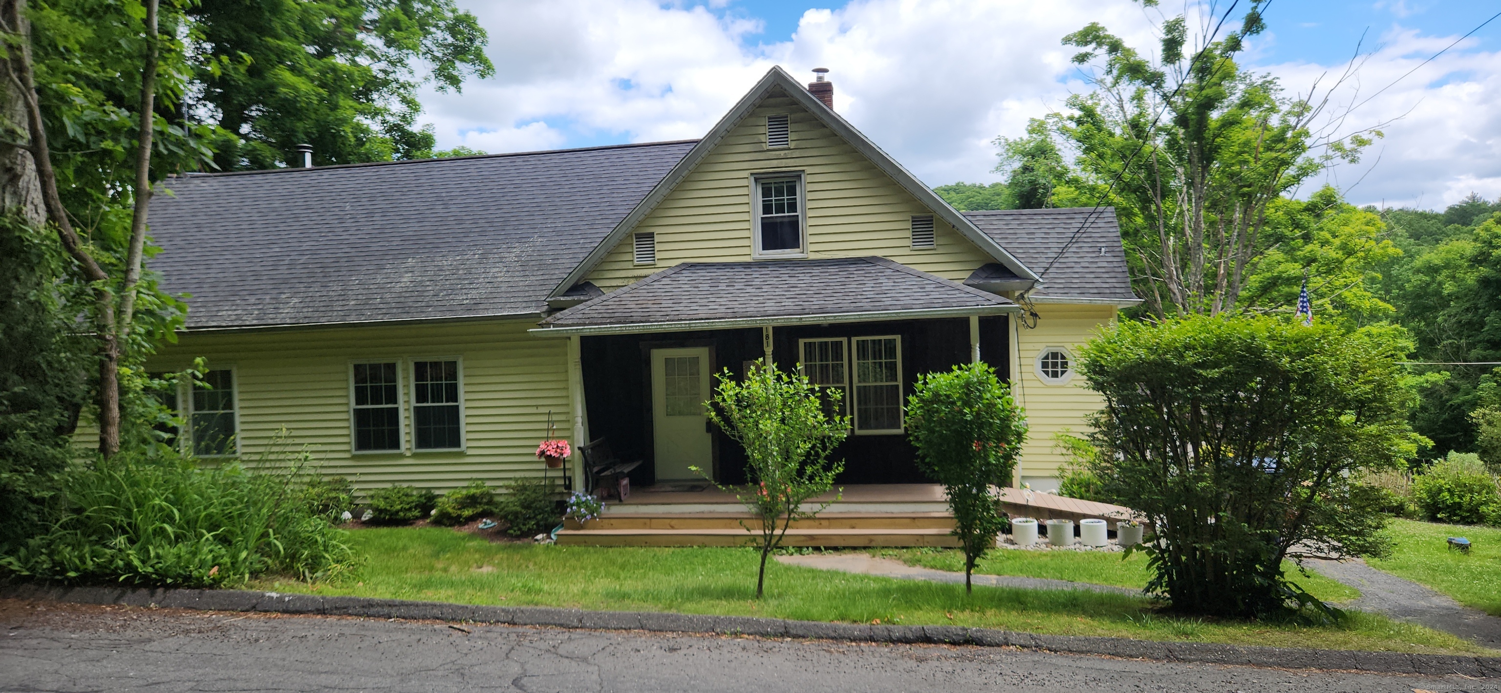 a front view of a house with a garden