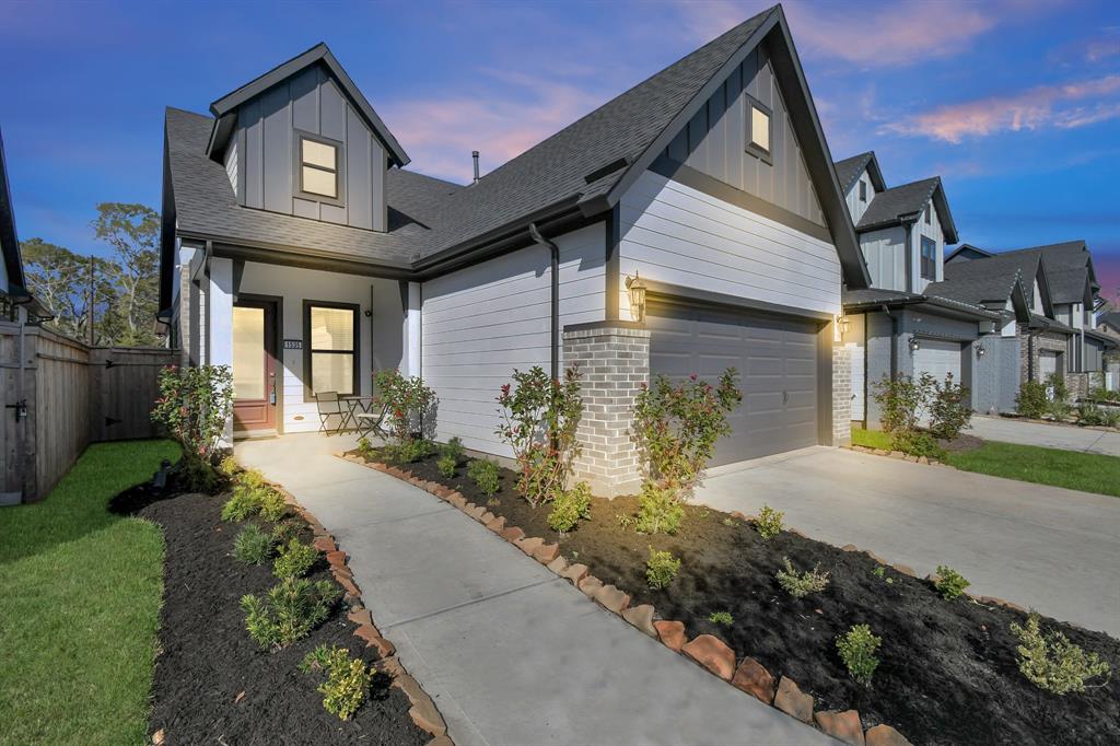 a front view of a house with a yard and outdoor seating