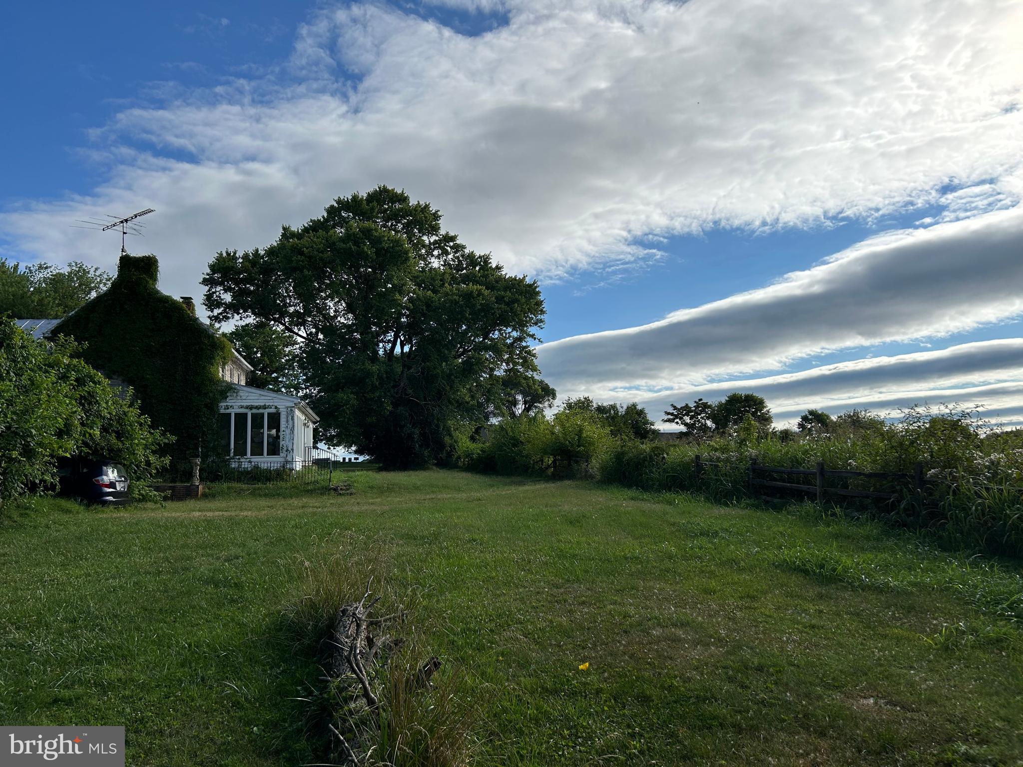 a view of a house with a big yard and garden