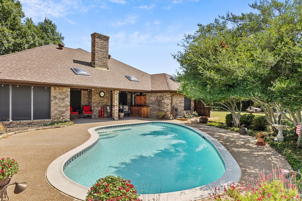 a view of a house with swimming pool and sitting area