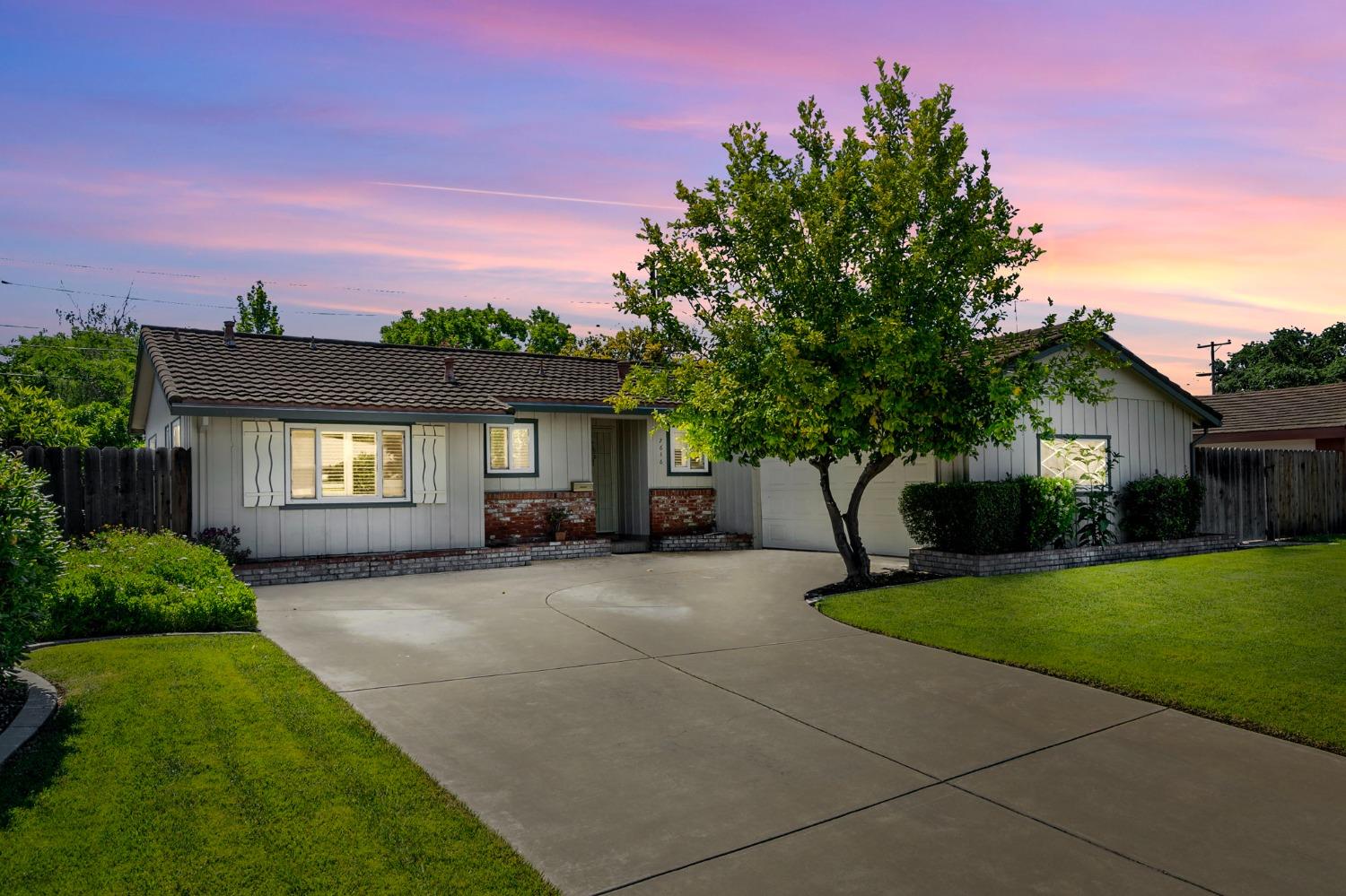 a front view of a house with yard patio and green space