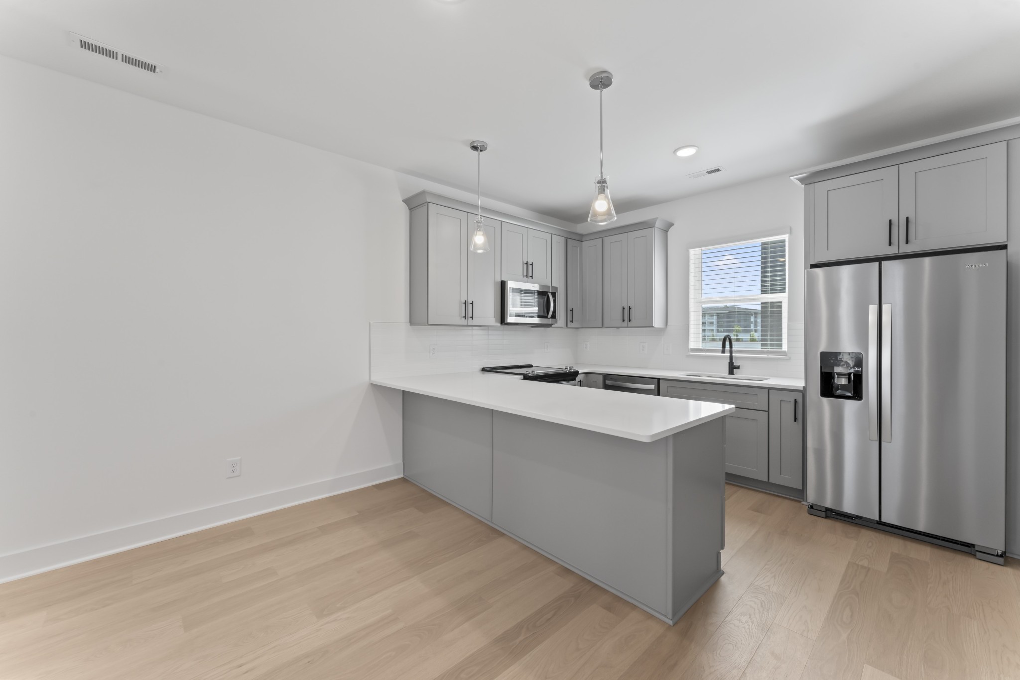 a kitchen with kitchen island a sink stainless steel appliances and cabinets