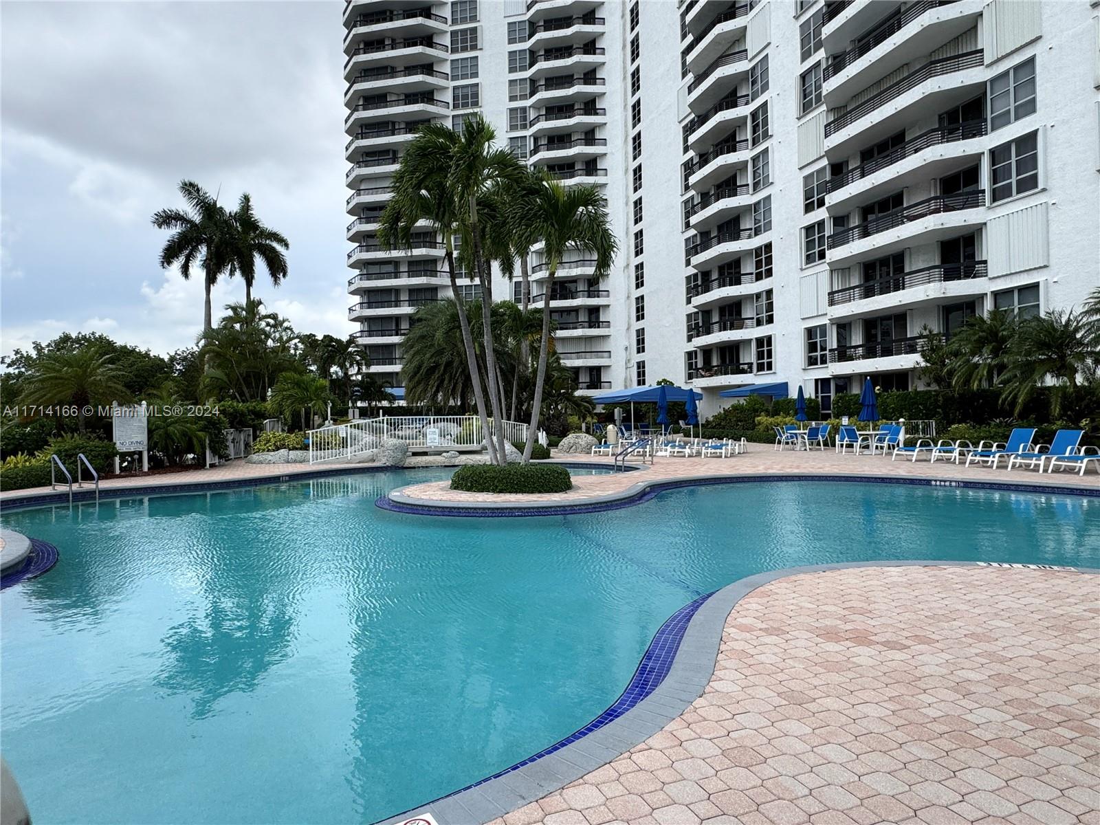 a view of swimming pool with outdoor seating and lake view