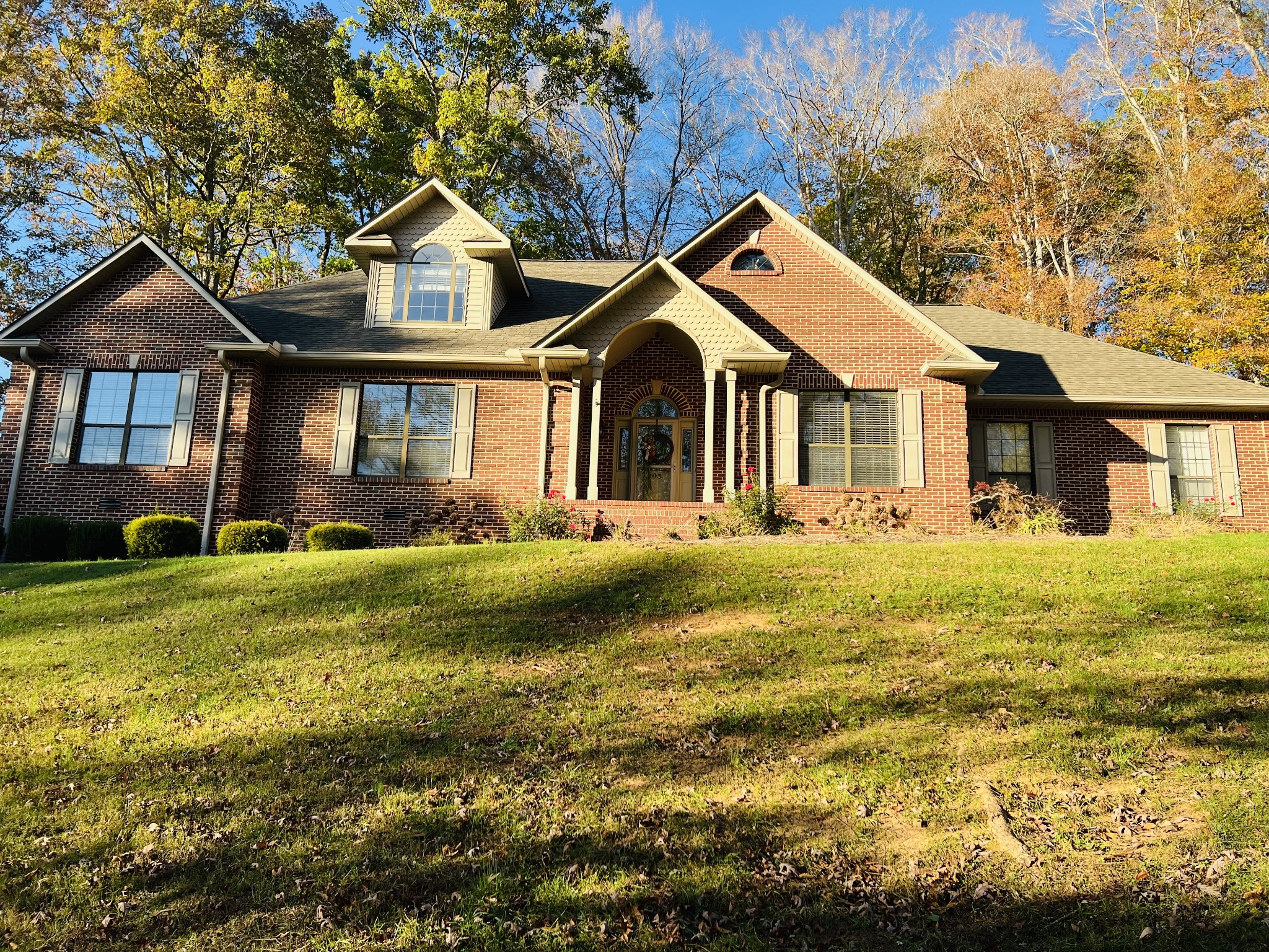 a front view of a house with a garden