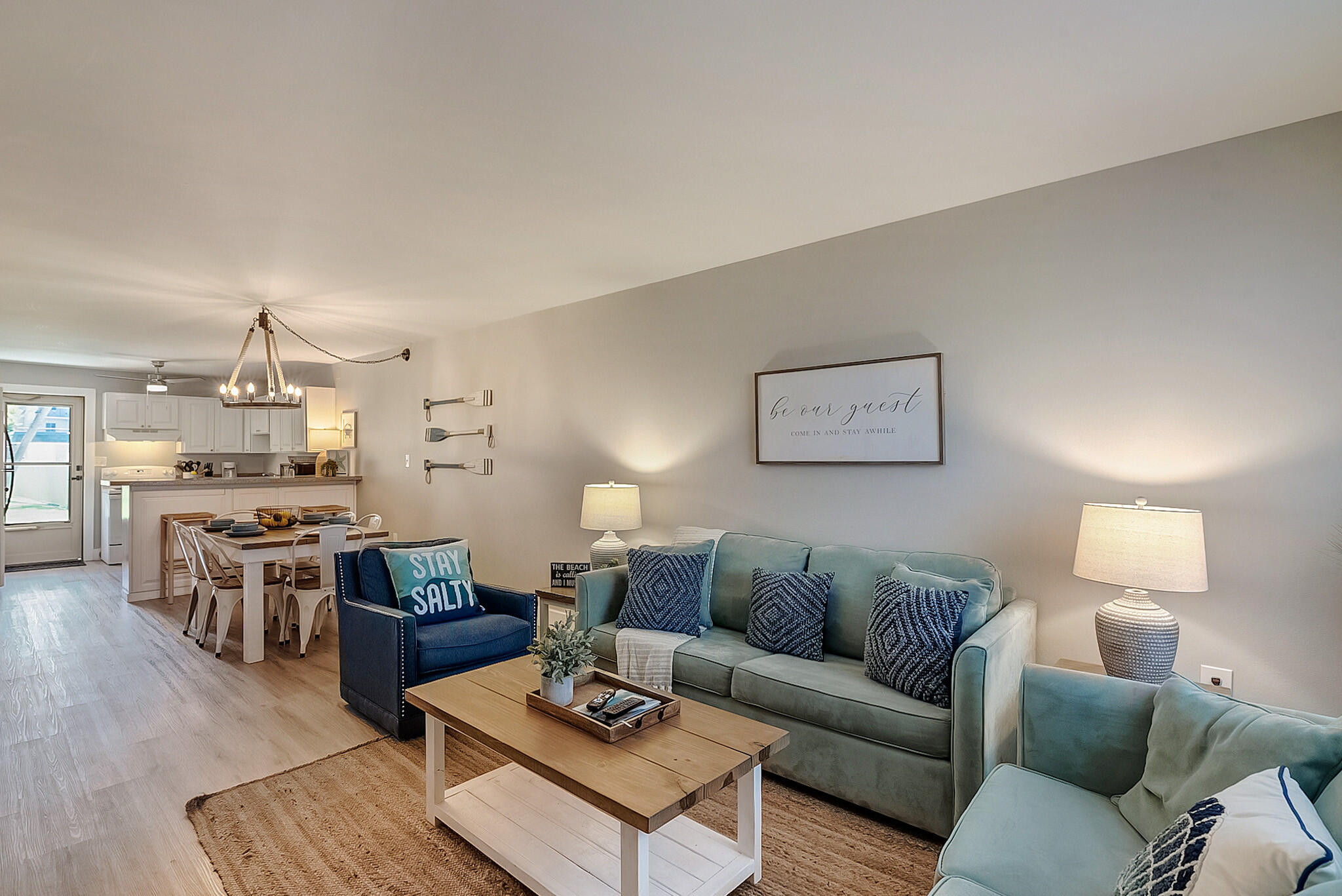 a living room with furniture kitchen view and a table