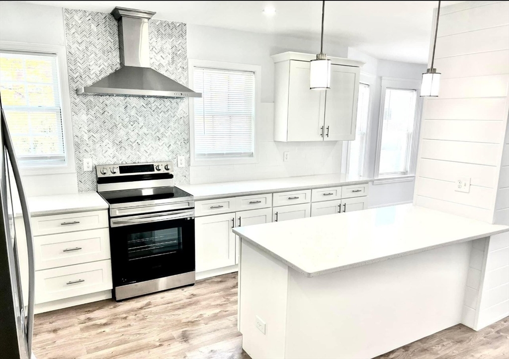 a kitchen with stainless steel appliances a stove a sink and a refrigerator