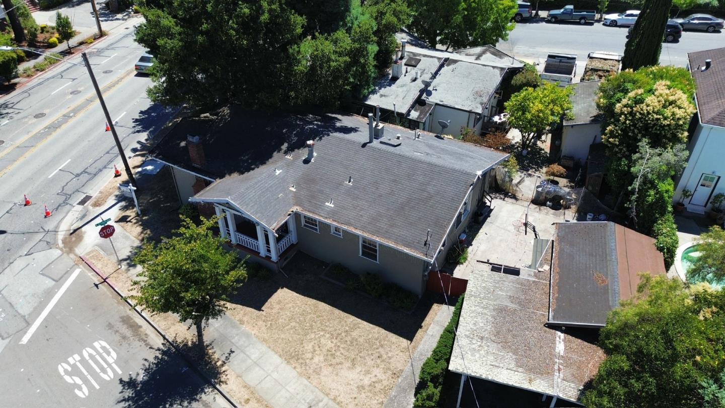 an aerial view of a house with a yard and potted plants