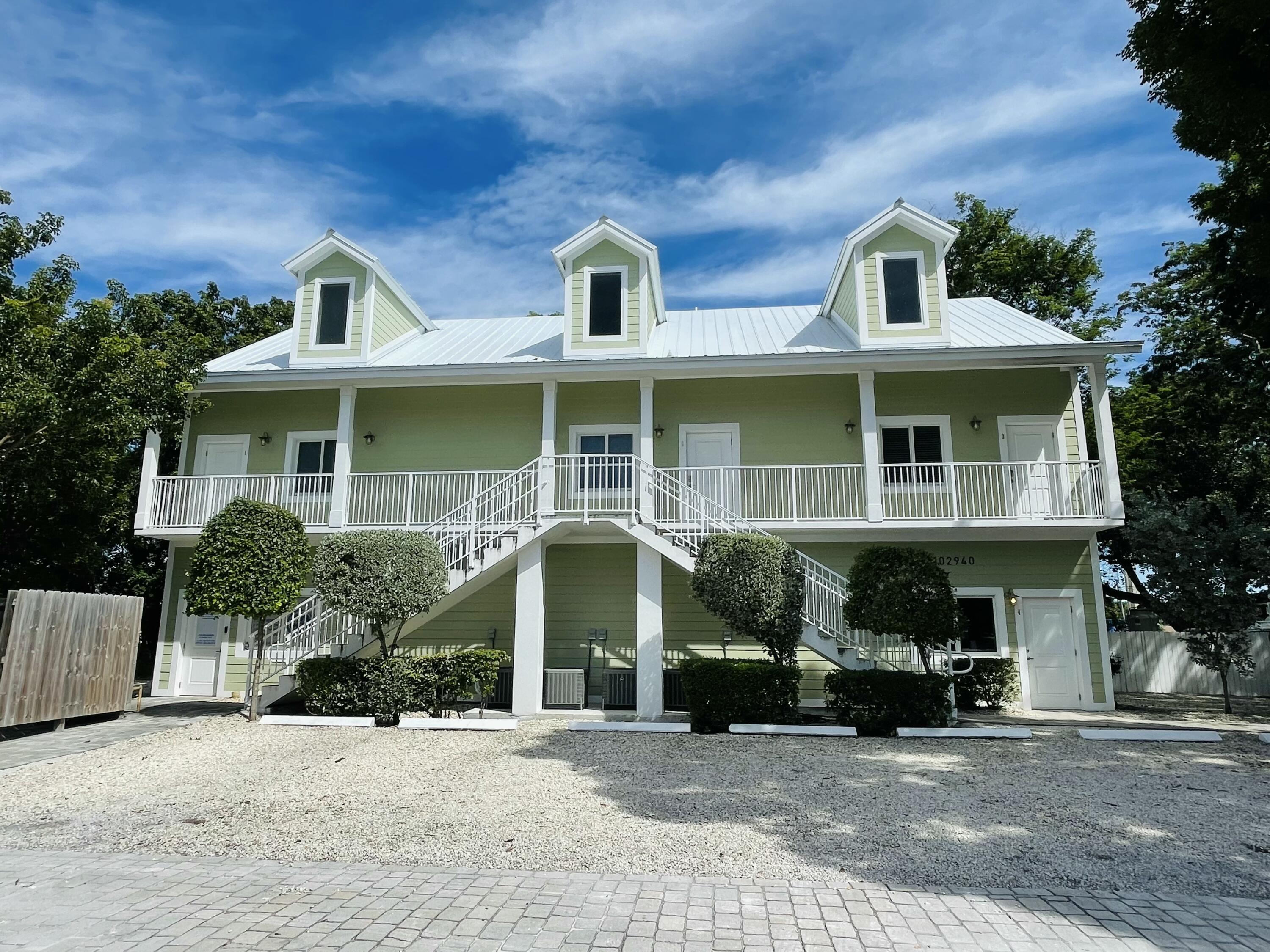 a front view of a house with glass windows and garage