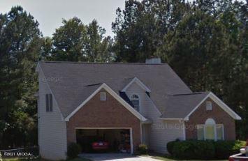 a aerial view of a house with a yard