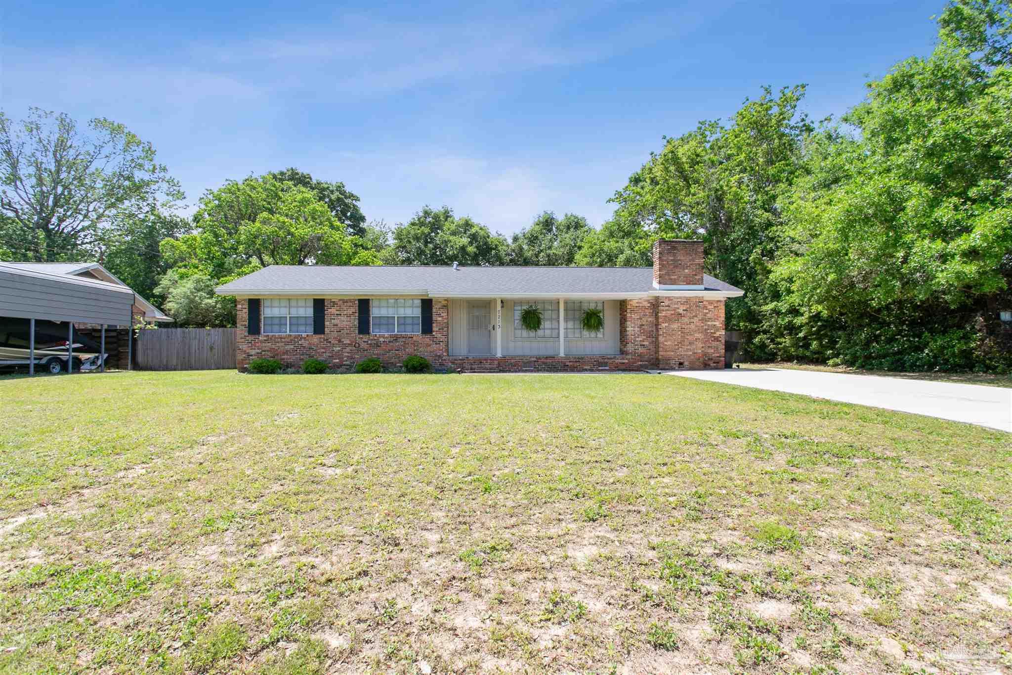 a front view of house with yard and swimming pool