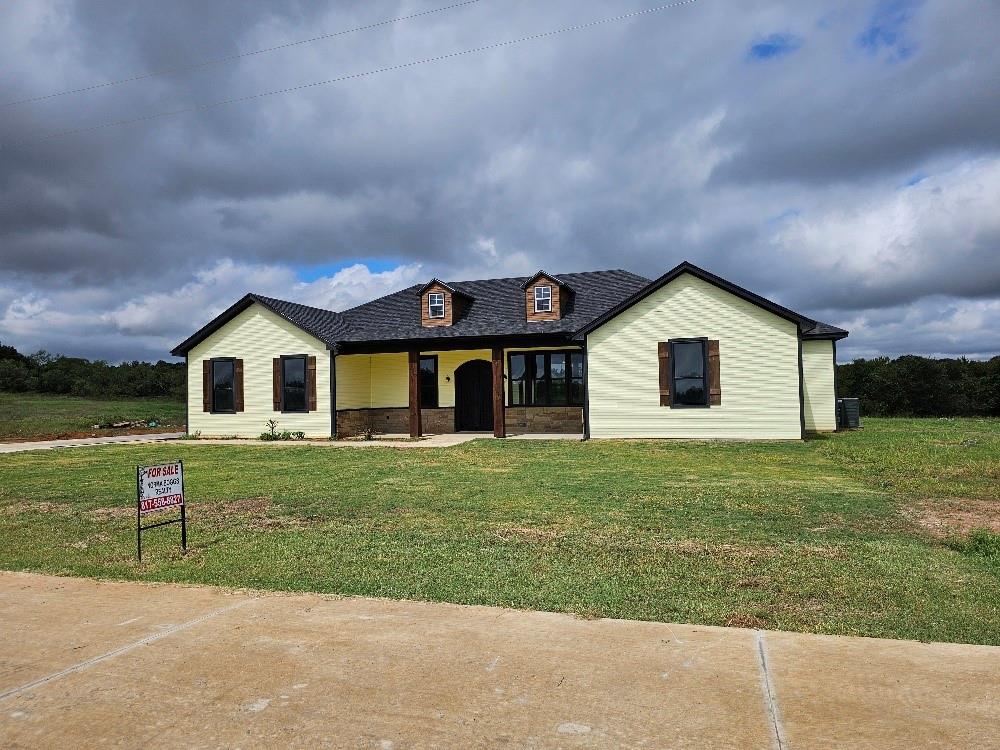 a front view of house with yard and green space