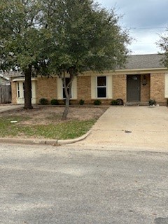 front view of a house with a yard and a garage