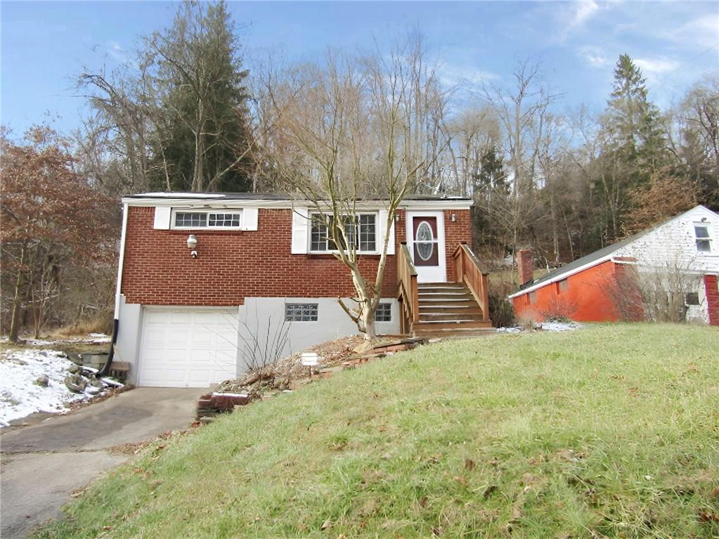 a aerial view of a house with a yard and trees