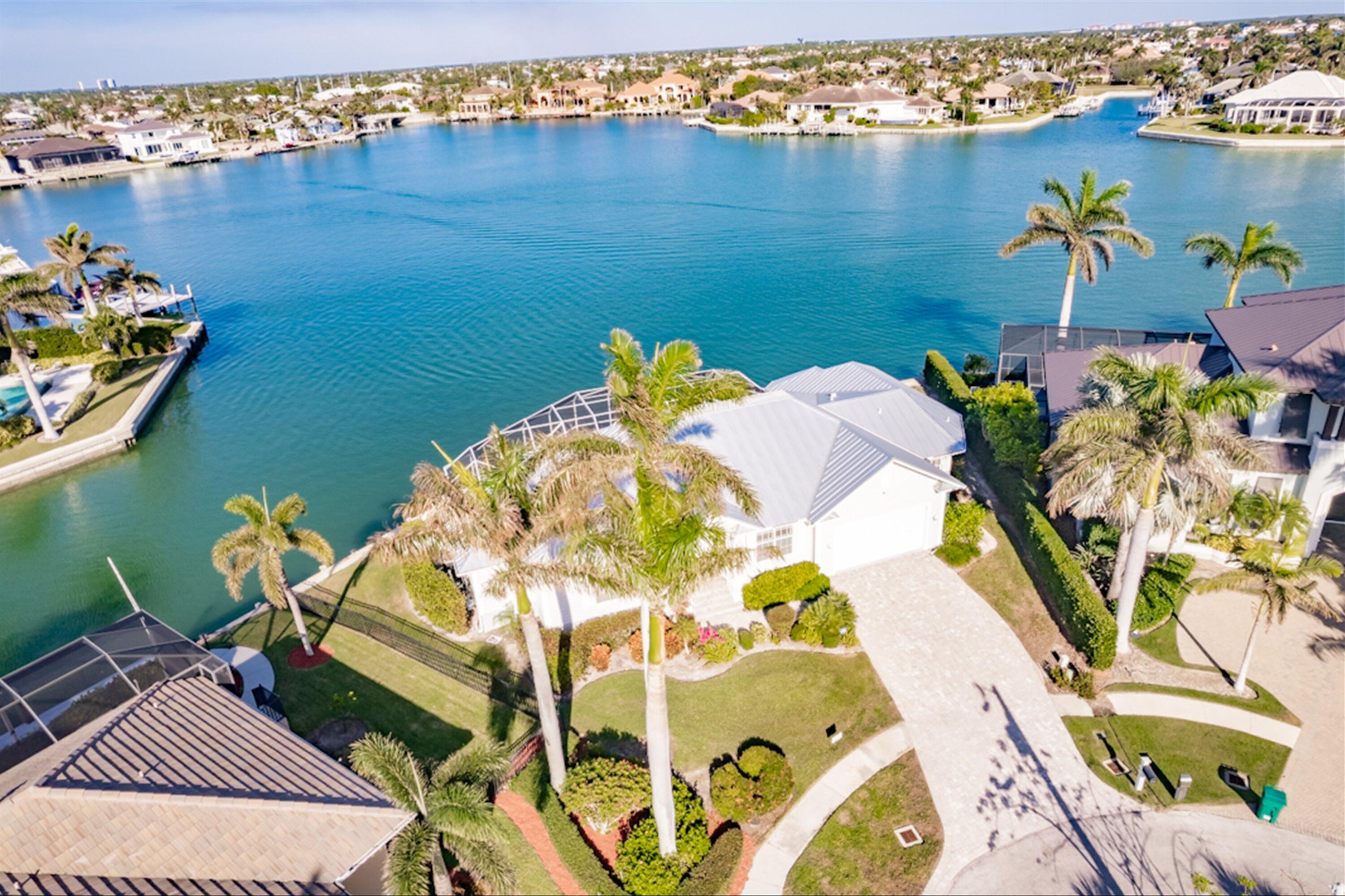 an aerial view of a house a swimming pool and outdoor seating