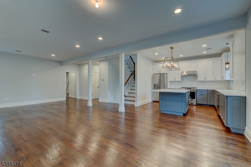 a view of kitchen with cabinets and wooden floor