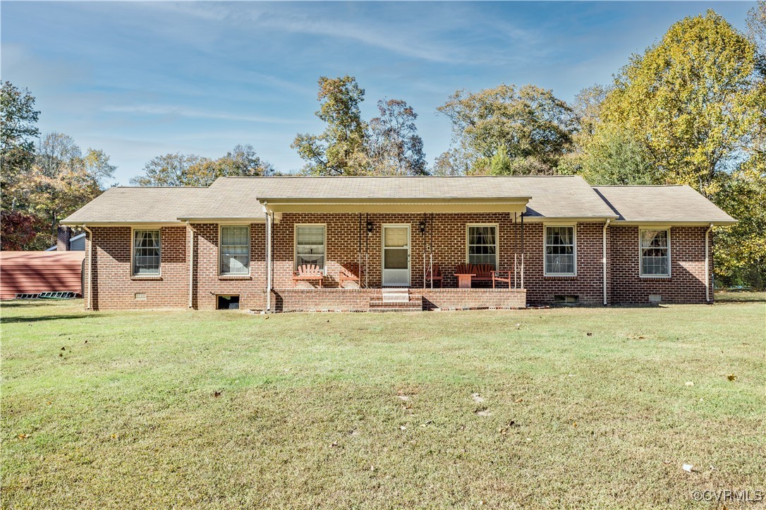 a view of a house with a yard and sitting area