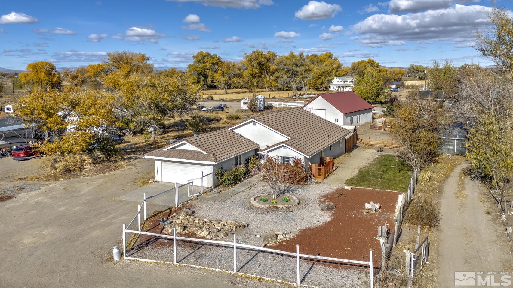 an aerial view of a house with garden space and street view