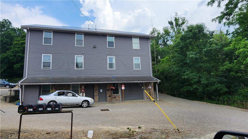 a front view of a house with parking space