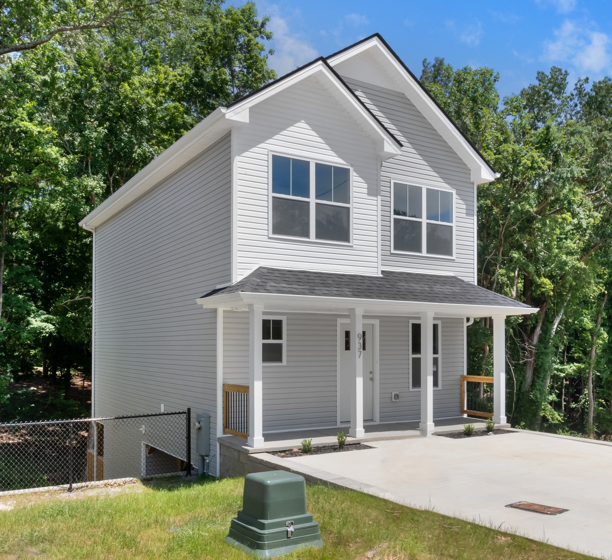 a front view of a house with a yard garage and outdoor seating