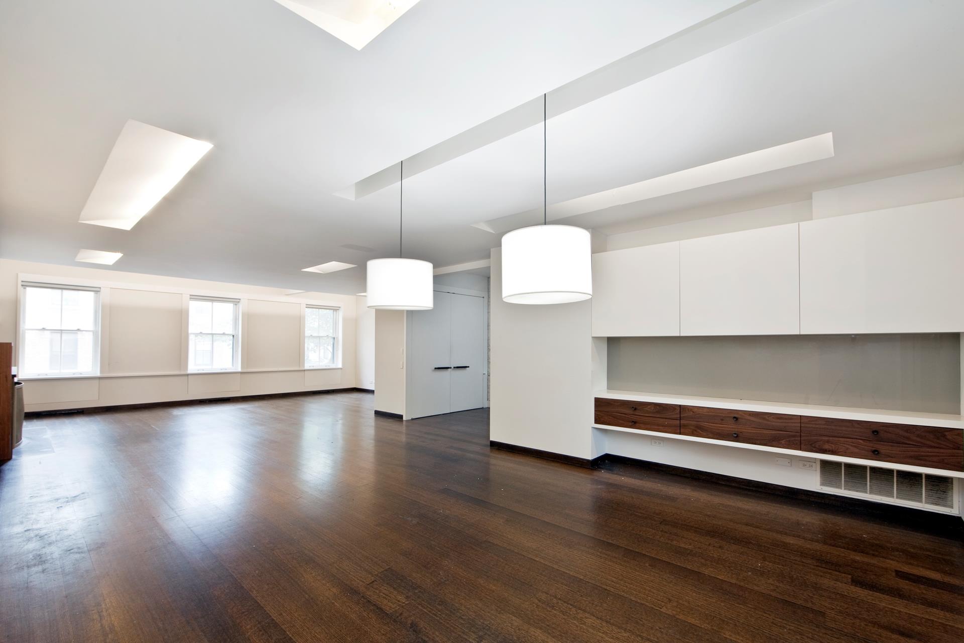 a view of a room with wooden floor and window