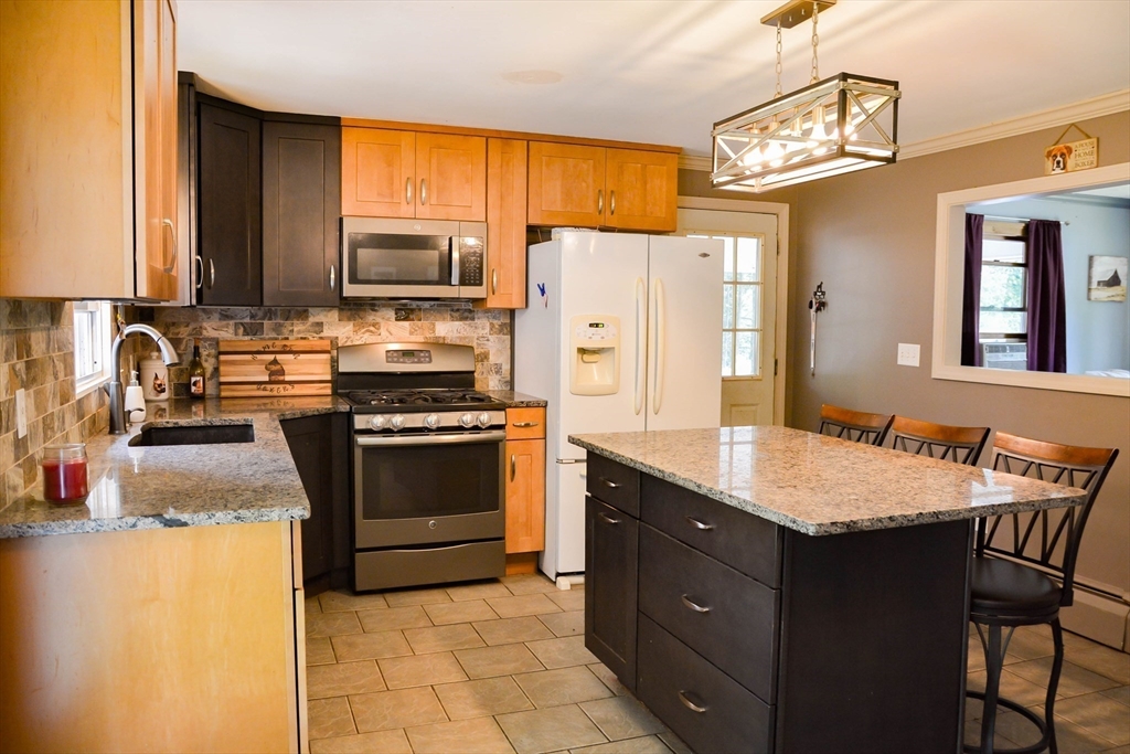 a kitchen with a stove a sink and a refrigerator