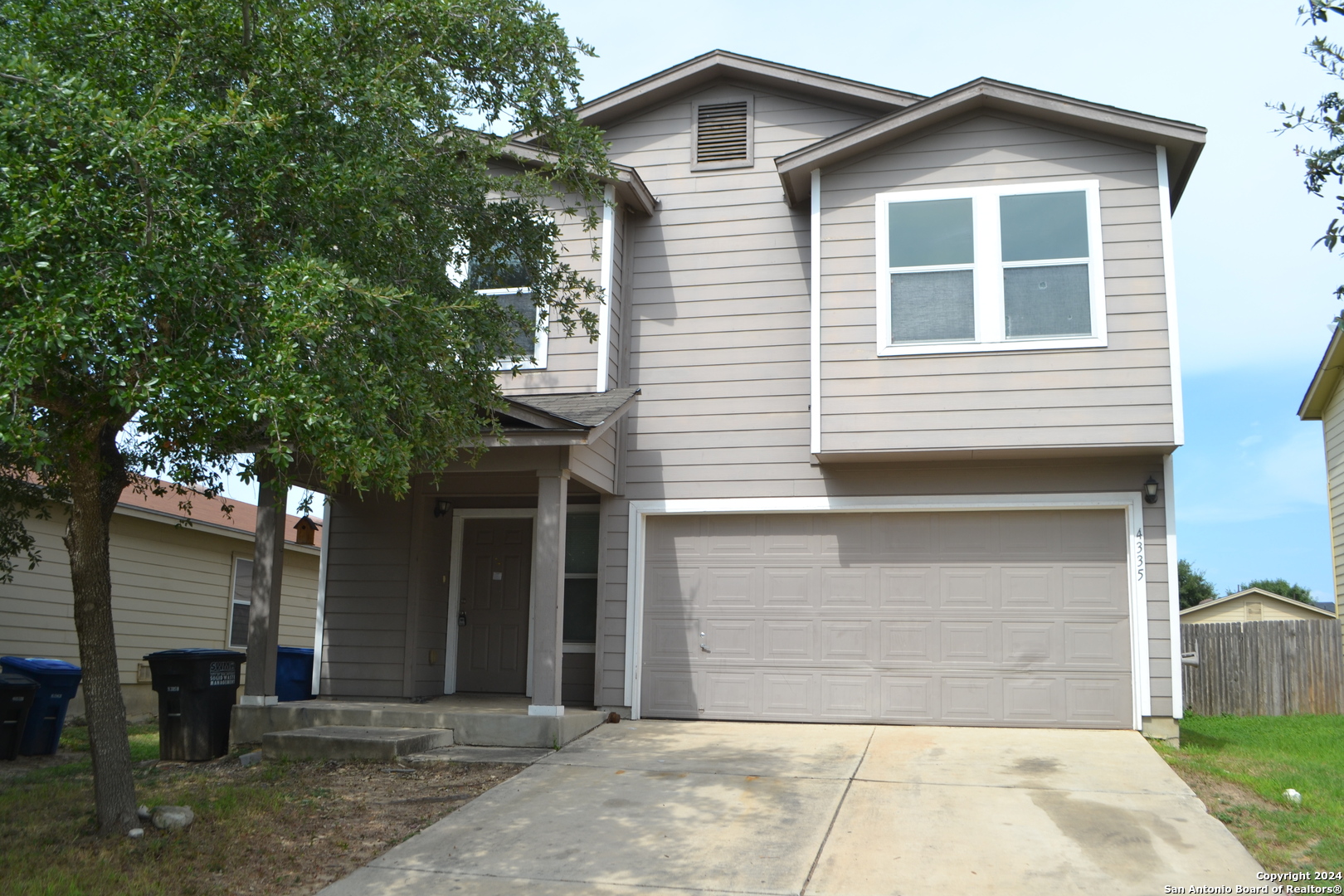 a front view of a house with garage