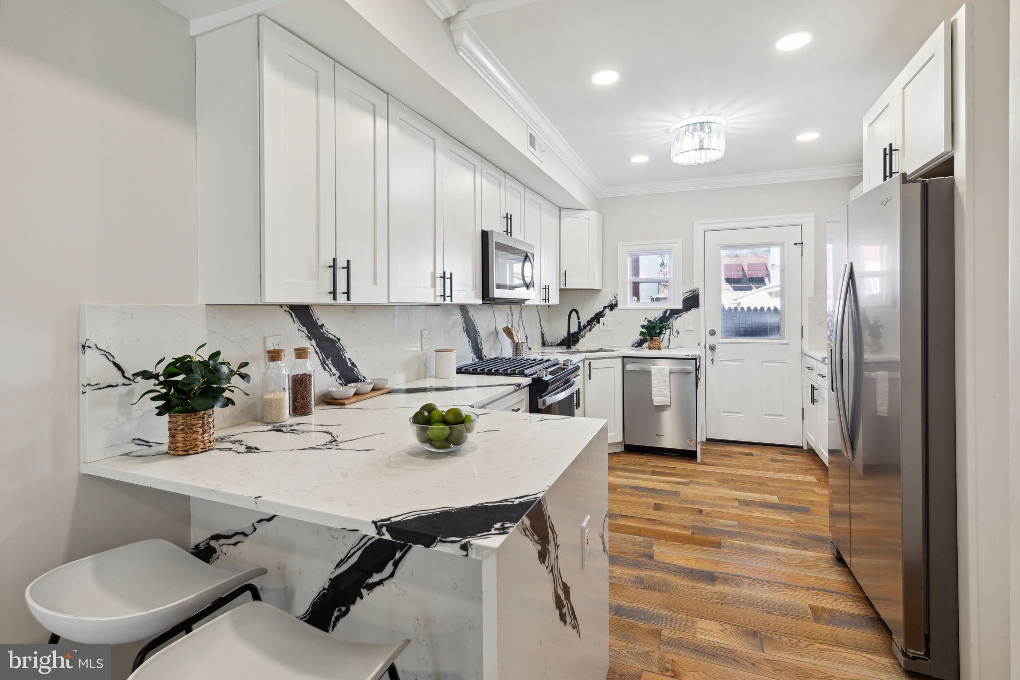 a kitchen with a sink appliances and cabinets