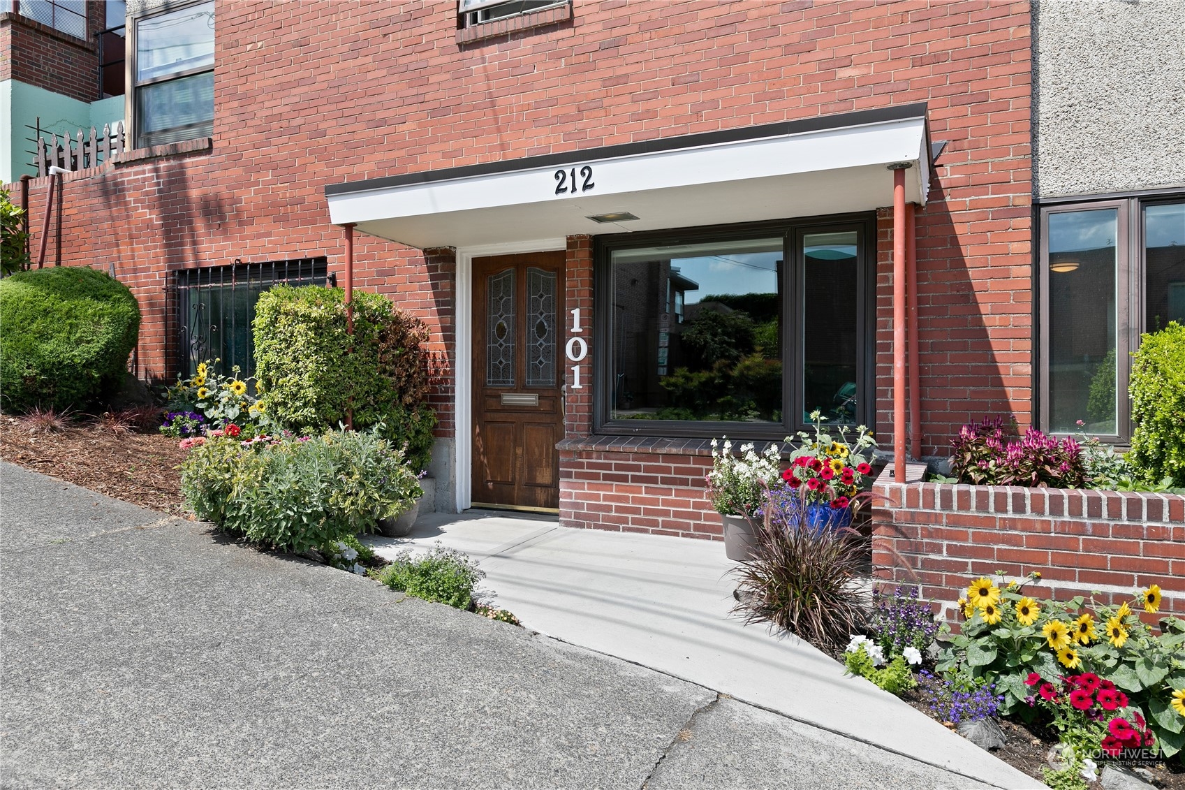 a view of a house with flower pots