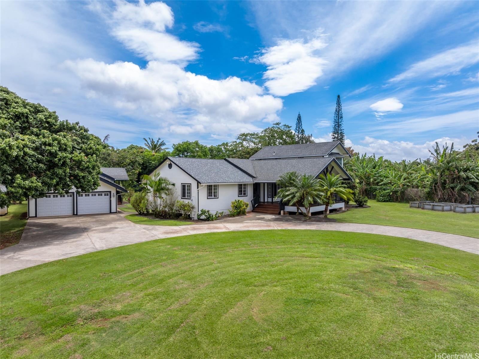 a view of a house with a big yard and a large tree