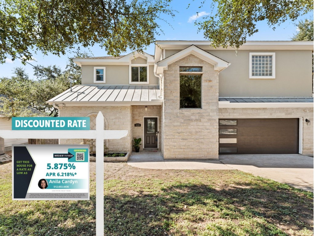 a front view of a house with garage