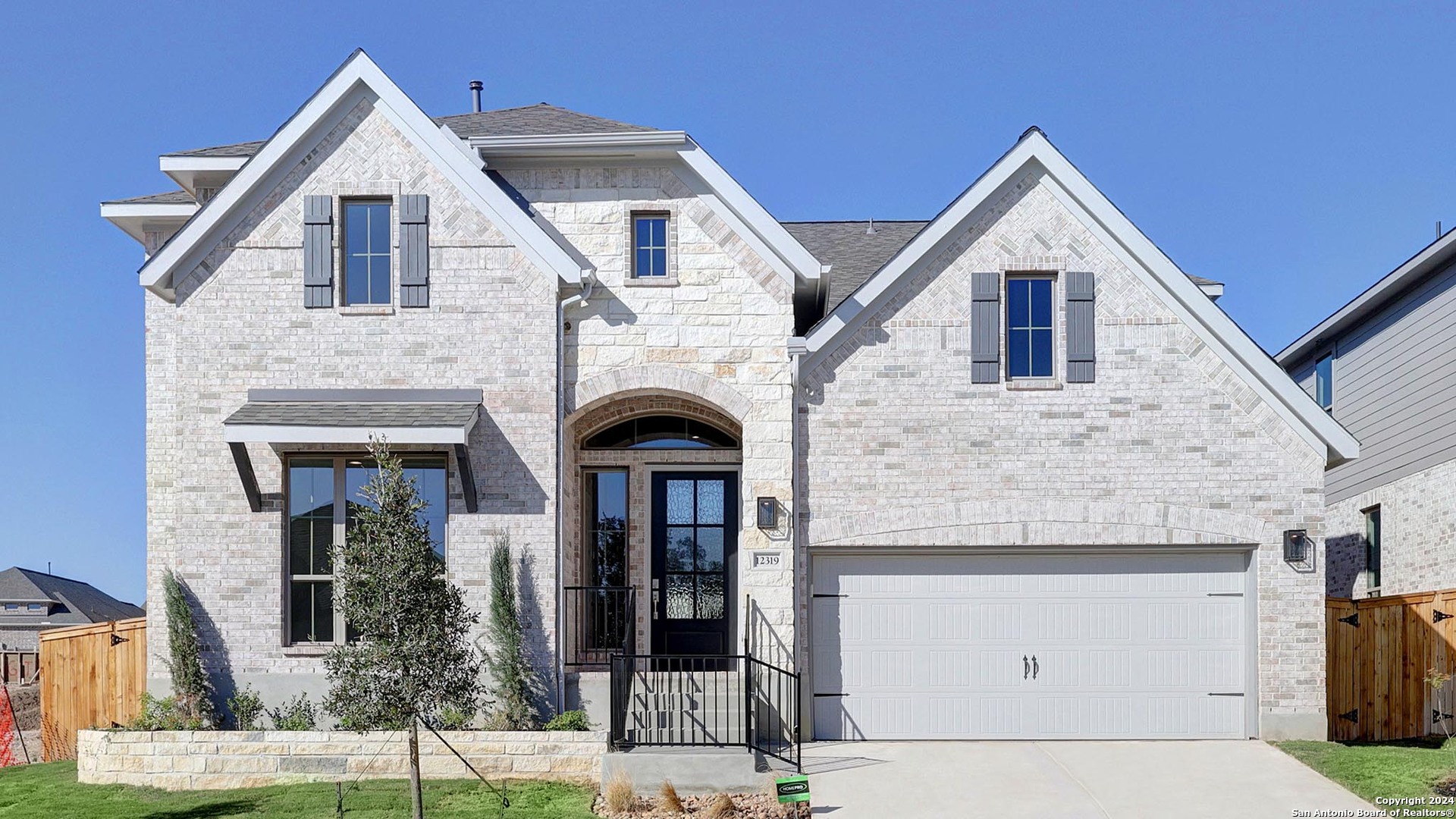 a front view of a house with garage